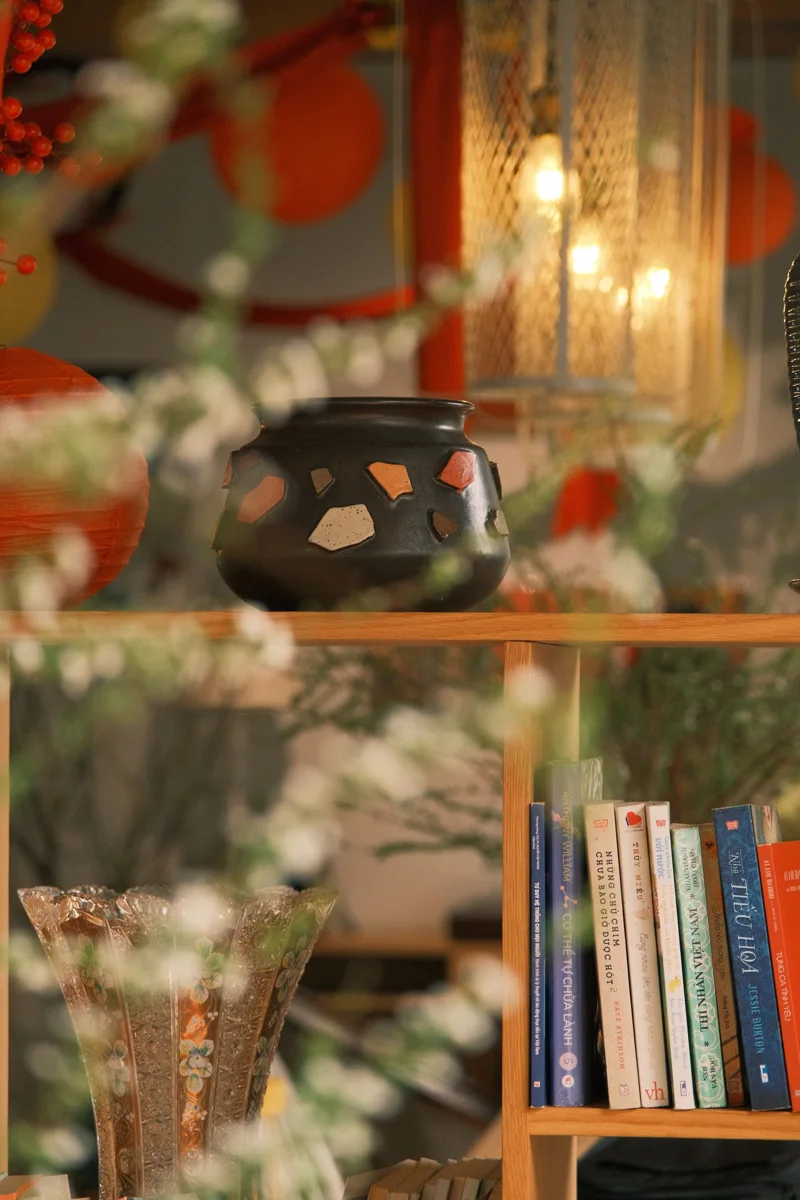 Vase and books in a furnished living room.
