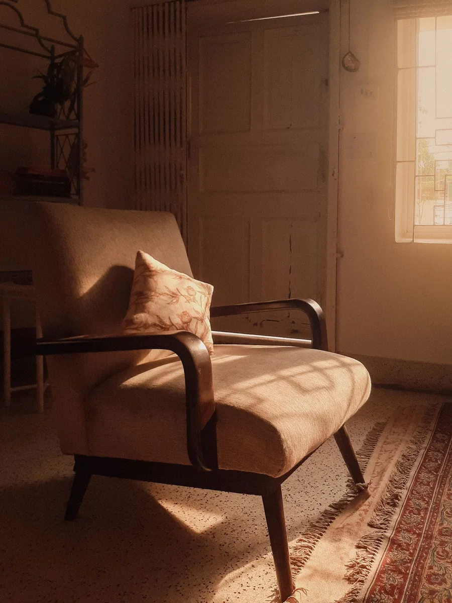 Vintage armchair beside a window.