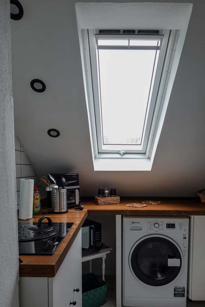 Compact kitchen with cabinets and appliances.