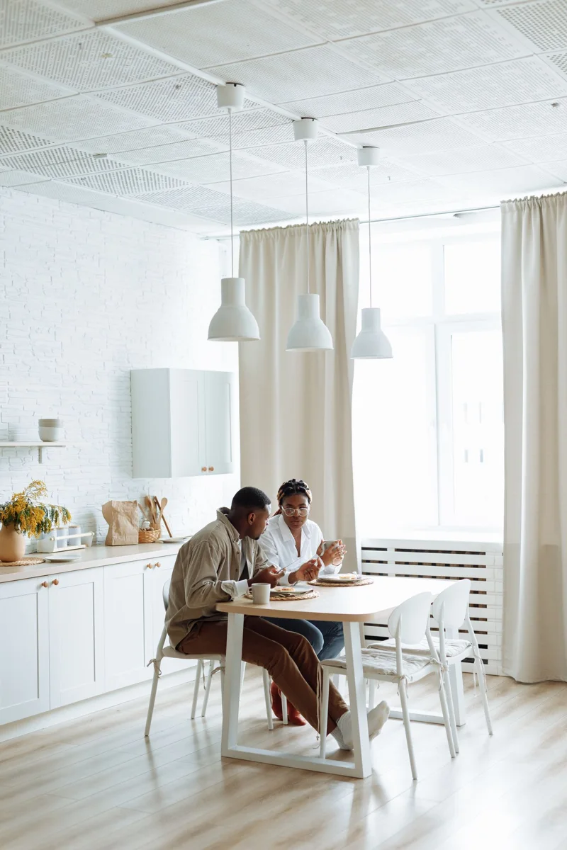 A man and a woman seated at a breakfast table
