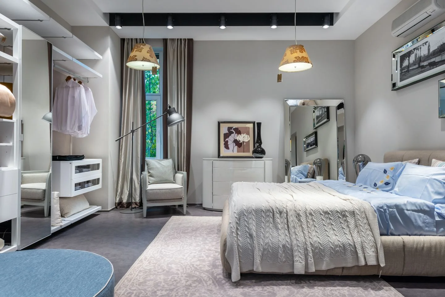 A furnished bedroom with a bed and wardrobe
