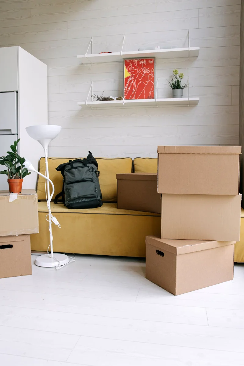 Moving boxes beside a sofa