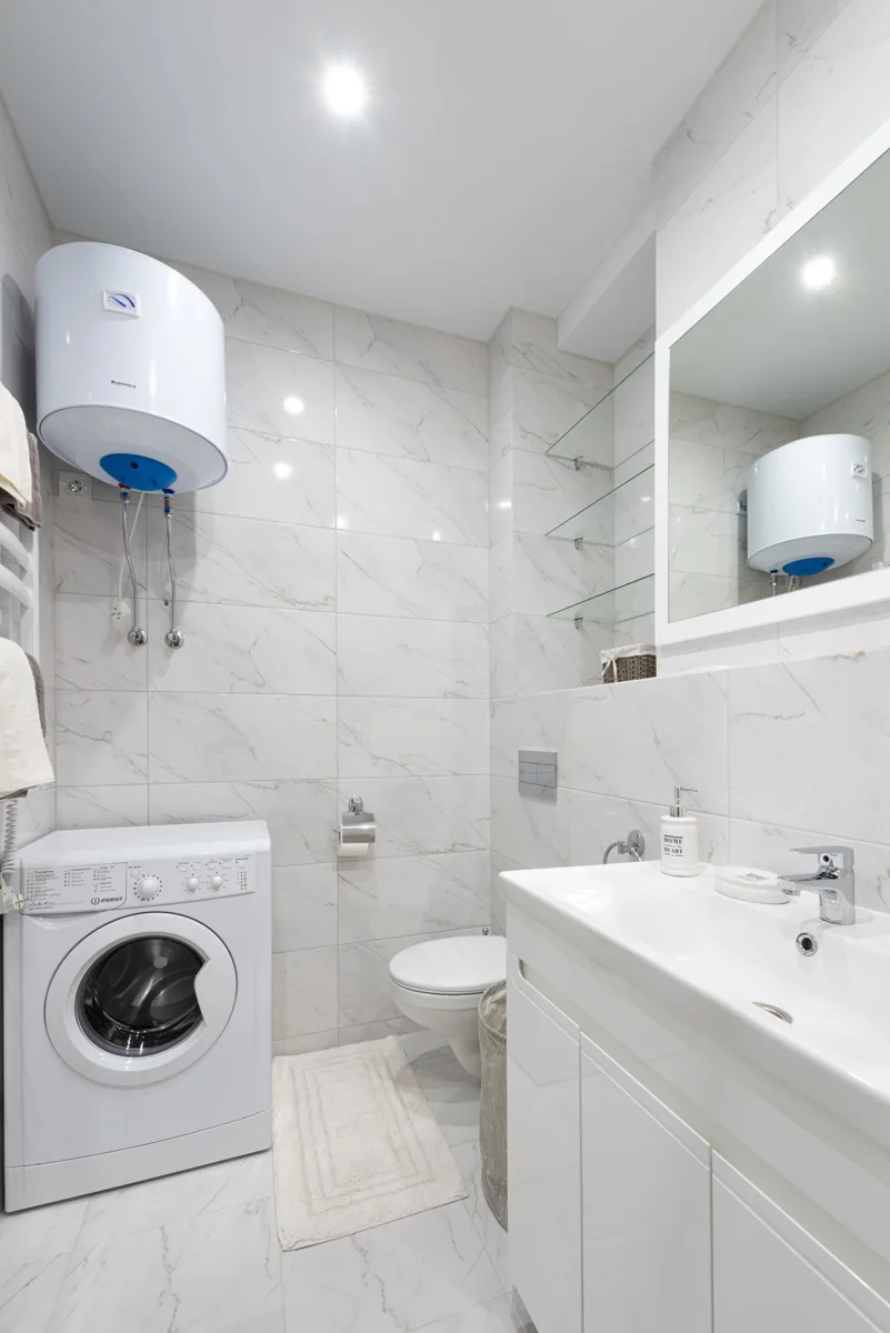 A white washing machine in a bathroom
