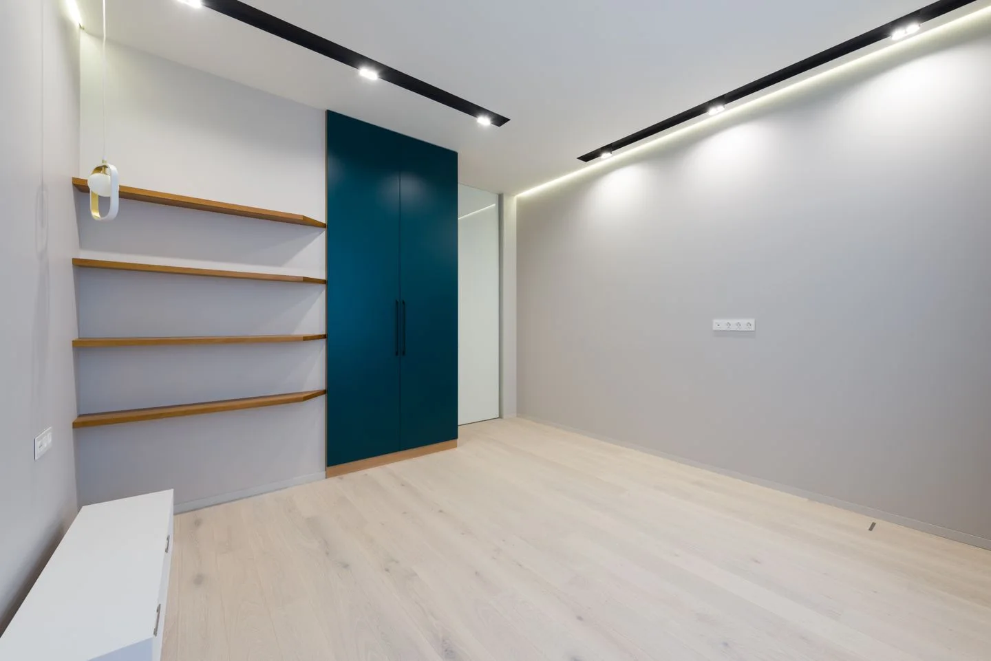 A furnished room with wooden furniture and laminate flooring