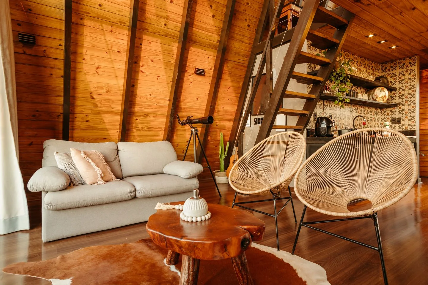 A cottage interior with a kitchen and seating area