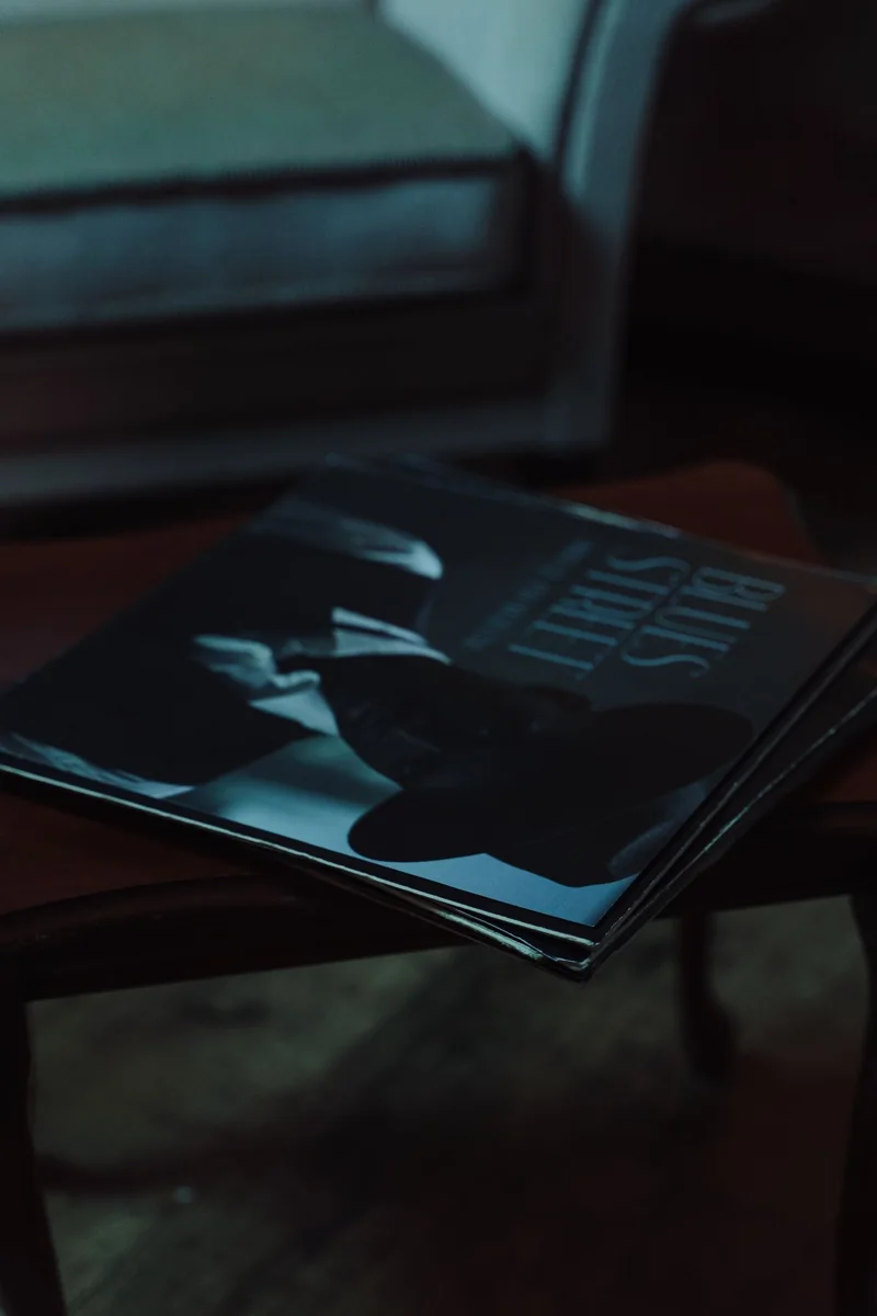 Vinyl records lie on a wooden table