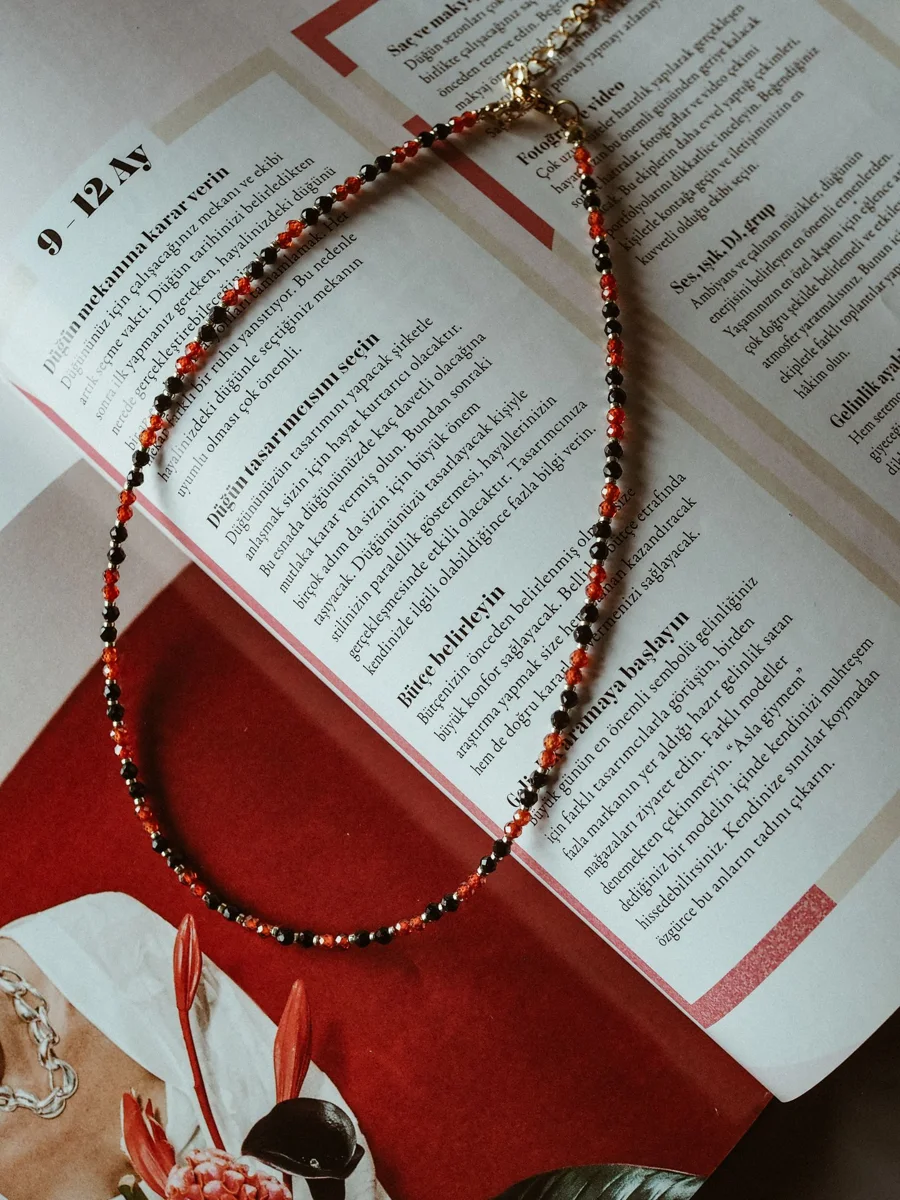 A beaded necklace on an open magazine
