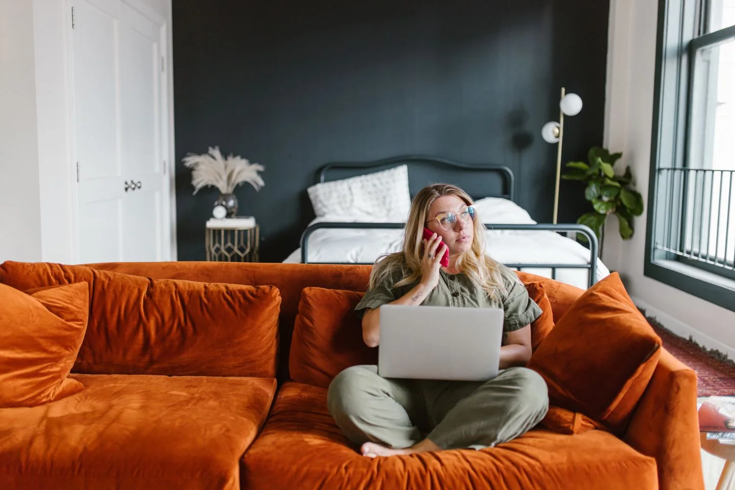 Woman making a phone call from a sofa