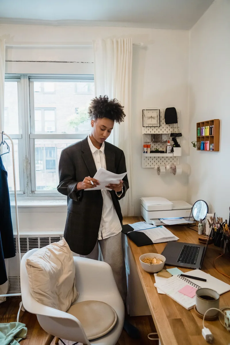 Woman reading documents at a home-office desk
