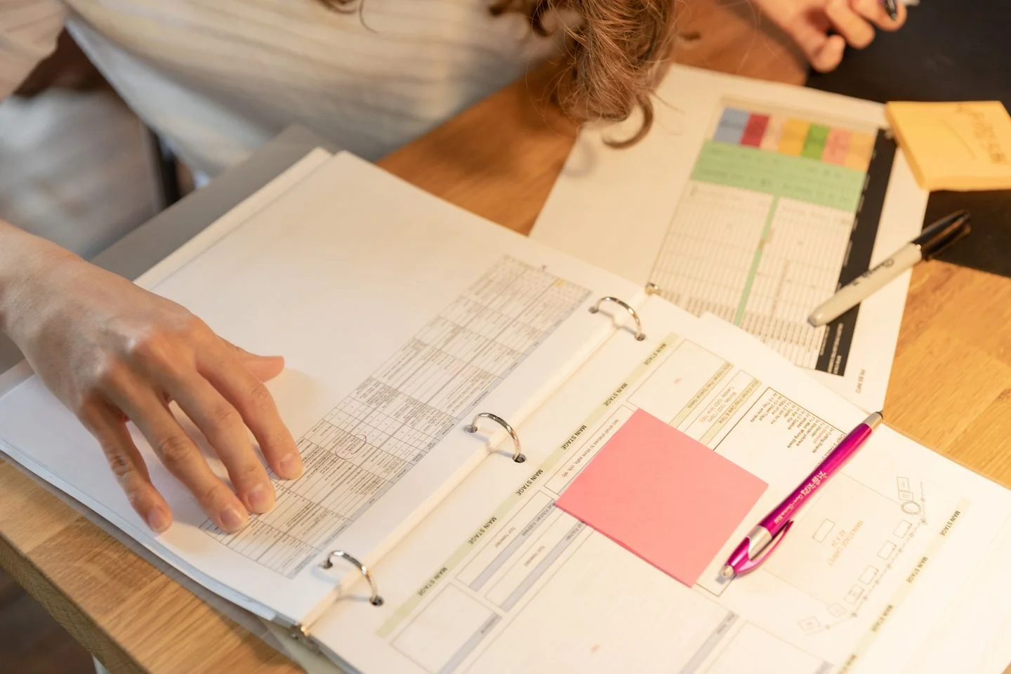 A person reads documents with sticky notes