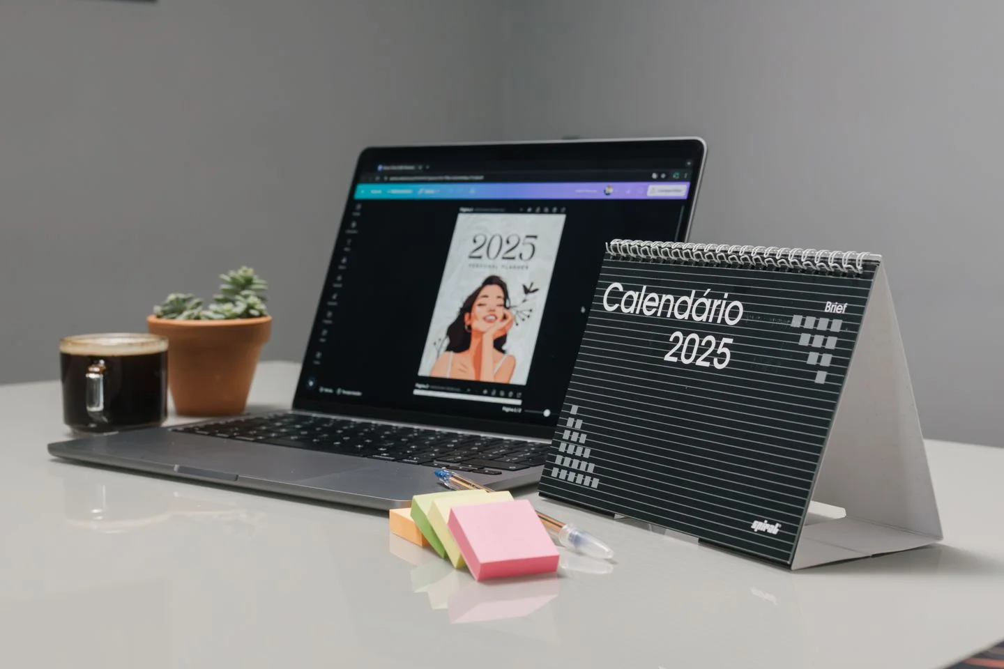A calendar beside a laptop