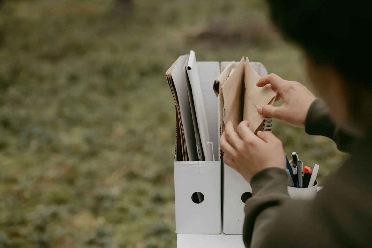 Hands organise documents in different folders
