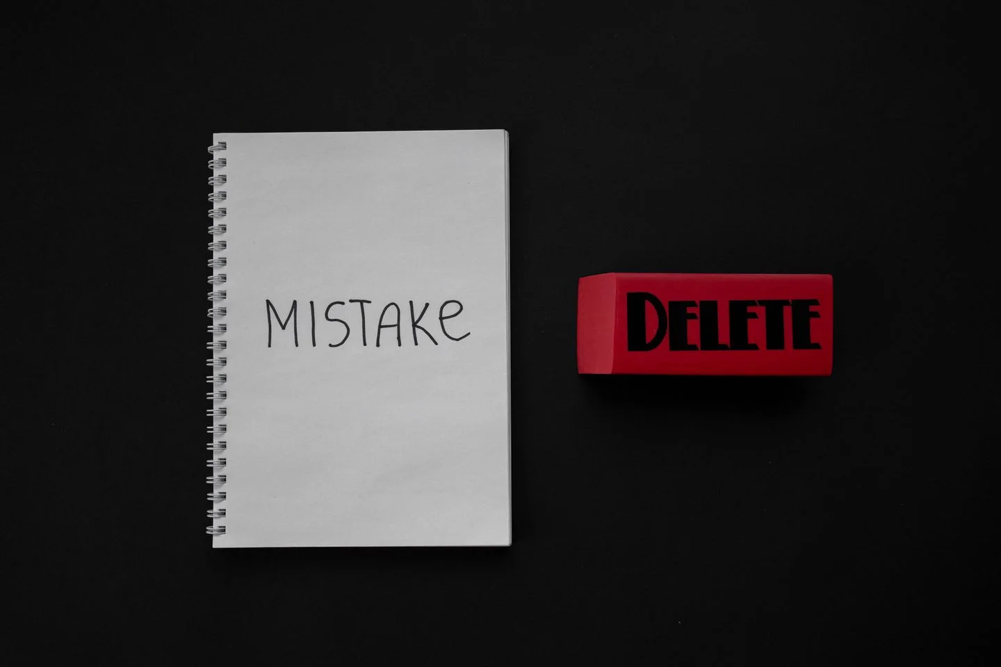 A notebook marked Mistake beside a red eraser